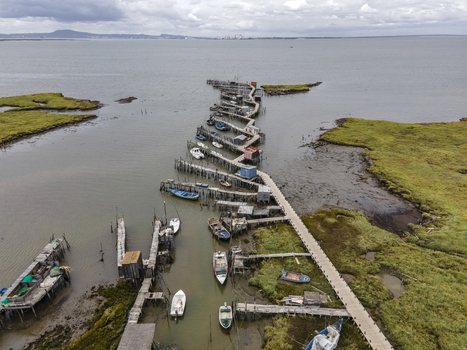 Aerial view of Porto Palafita da Carrasqueira a beautiful pier made of wood by fishermen renowned for its sunset view Comporta Troia Peninsula Setubal Portugal.