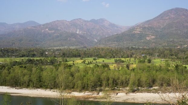 View of lush green fields and mountains Nepal.