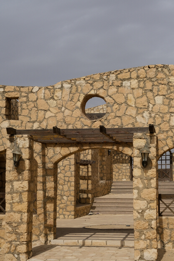 View of stone arches and pergolas create a textured pathway under a cloudy sky in a desert landscape Cairo Cairo Governorate Egypt. View of stone arches and pergolas create a textured pathway under a cloudy sky in a desert landscape Cairo Cairo Governorate Egypt.