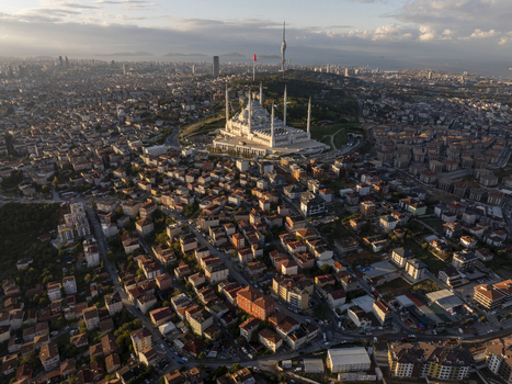 Aerial view of Grand Camlica Mosque surrounded by dense urban residential buildings hills and the distant skyline of Istanbul in Uskudar Istanbul Turkiye. Aerial view of Grand Camlica Mosque surrounded by dense urban residential buildings hills and the distant skyline of Istanbul in Uskudar Istanbul Turkiye.