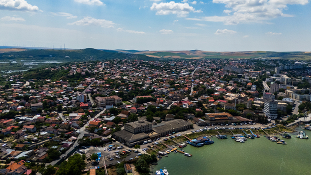 Aerial view of the city of Tulcea showing the urban landscape rooftops and the Danube Delta waterfront with boats docked along the shore in Tulcea Tulcea Romania.