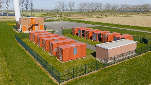 Aerial view of battery storage system at wind park with wind turbines