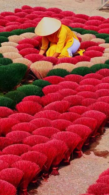 View of a person among vibrant red incense Vietnam.