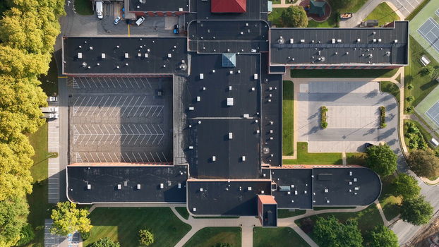 Aerial view of a large building complex with flat roofs parking lots and surrounding green spaces in Lancaster Pennsylvania United States.