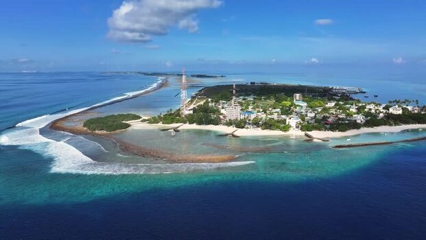 Aerial view of Thulusdhoo island and coral reefs Maldives.
