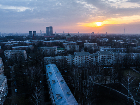 Aerial view of the Agenskalna priedes residential area featuring apartment blocks and bare trees under a vibrant sunset sky in Riga Latvia. Aerial view of the Agenskalna priedes residential area featuring apartment blocks and bare trees under a vibrant sunset sky in Riga Latvia.