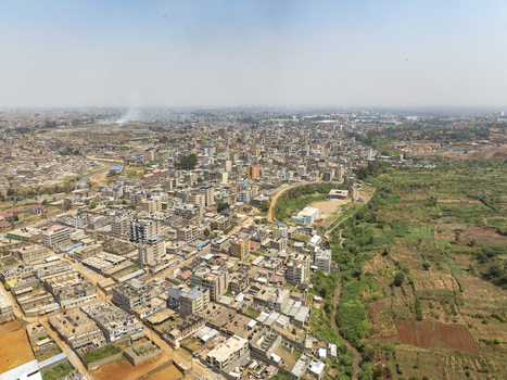 Aerial view of the Lucky Summer neighborhood featuring dense residential buildings and adjacent agricultural land in Nairobi Nairobi County Kenya. Aerial view of the Lucky Summer neighborhood featuring dense residential buildings and adjacent agricultural land in Nairobi Nairobi County Kenya.