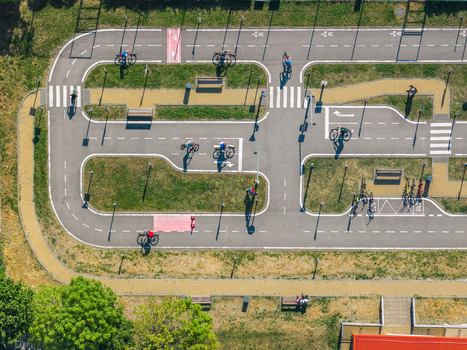 Aerial view of a traffic education park with children cycling on paths with road markings crosswalks and benches in Kyjov South Moravian Region Czechia.