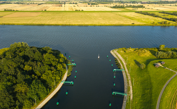 Aerial view of the Vistula River flowing through lush green banks and agricultural fields in Pomeranian Voivodeship Poland. Aerial view of the Vistula River flowing through lush green banks and agricultural fields in Pomeranian Voivodeship Poland.