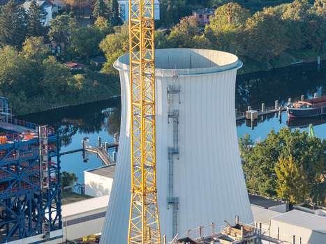 Aerial view of the cooling tower at the Combined Heat and Power Plant Lichterfelde with a tall yellow crane and industrial structures near the Teltow Canal in Berlin Berlin Germany. Aerial view of the cooling tower at the Combined Heat and Power Plant Lichterfelde with a tall yellow crane and industrial structures near the Teltow Canal in Berlin Berlin Germany.