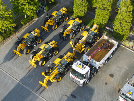 Krakow Poland 16 September 2026 Aerial view of a fleet of yellow telehandlers and a white truck with a crane parked in a machinery yard.