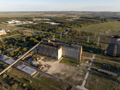 Aerial view of the abandoned Inota Power Plant with its iconic cooling towers industrial buildings and conveyor belt system in Varpalota Hungary. Aerial view of the abandoned Inota Power Plant with its iconic cooling towers industrial buildings and conveyor belt system in Varpalota Hungary.