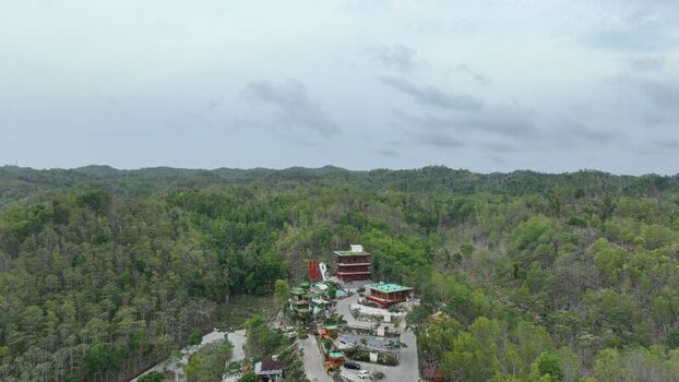 Aerial view of Obelix Sea View nestled amidst lush green hills and dense forest with modern buildings and winding access roads in Kecamatan Purwosari Daerah Istimewa Yogya Indonesia. Aerial view of Obelix Sea View nestled amidst lush green hills and dense forest with modern buildings and winding access roads in Kecamatan Purwosari Daerah Istimewa Yogya Indonesia.