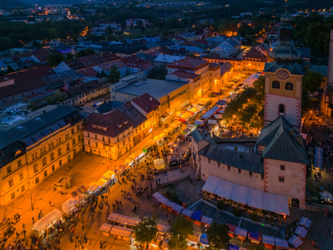 Aerial view of Radvansky jarmok traditional market with illuminated stalls and crowds of people in the historic square of Banska Bystrica Banskobystricky kraj Slovakia.
