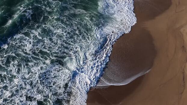 Aerial view of beach and ocean waves Portugal.