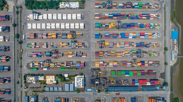 Aerial view of the Jawaharlal Nehru Port Authority container terminal with rows of colorful shipping containers and industrial infrastructure in Juna Sheva Maharashtra India. Aerial view of the Jawaharlal Nehru Port Authority container terminal with rows of colorful shipping containers and industrial infrastructure in Juna Sheva Maharashtra India.