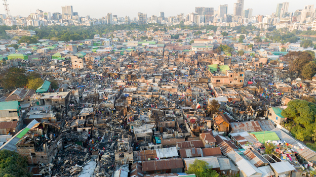 Aerial view of starkly contrasted scenes of destruction and resilience with charred remains against a backdrop of modern cityscapes Dhaka Dhaka Division Bangladesh. Aerial view of starkly contrasted scenes of destruction and resilience with charred remains against a backdrop of modern cityscapes Dhaka Dhaka Division Bangladesh.