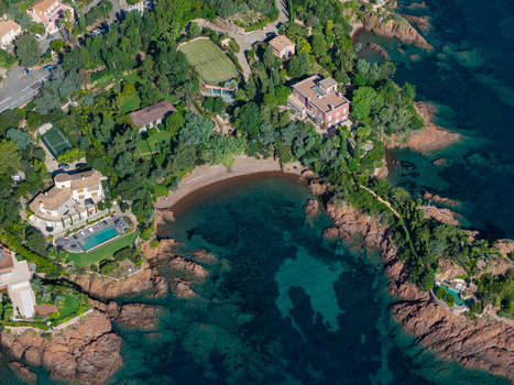 Aerial view of Le Trayas featuring a secluded beach with turquoise water rocky coastline and luxury villas surrounded by lush greenery in Saint Raphael Provence Alpes Cote d Azur France. Aerial view of Le Trayas featuring a secluded beach with turquoise water rocky coastline and luxury villas surrounded by lush greenery in Saint Raphael Provence Alpes Cote d Azur France.