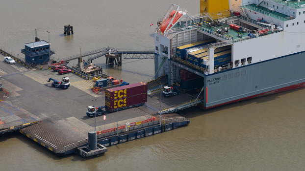Purfleet on Thames United Kingdom 10 July 2026 Aerial view of the Purfleet container terminal with a cargo ship being loaded with shipping containers by terminal tractors.