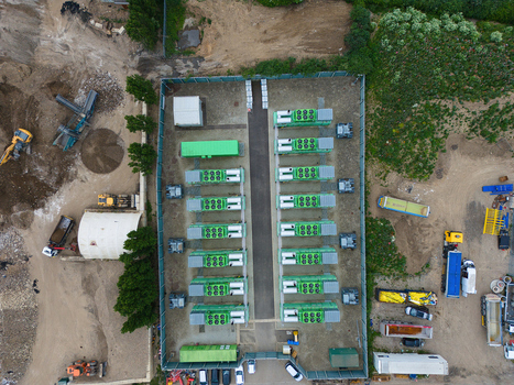 Aerial view of Damhead Creek Power Station Battery Energy Storage Systems BESS featuring rows of green units within a fenced facility in Rochester England United Kingdom. Aerial view of Damhead Creek Power Station Battery Energy Storage Systems BESS featuring rows of green units within a fenced facility in Rochester England United Kingdom.