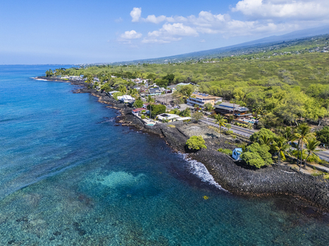 Aerial view of Kahalu u Beach Park featuring turquoise waters and black lava rock coastline with lush tropical greenery in Kailua Kona Hawaii United States. Aerial view of Kahalu u Beach Park featuring turquoise waters and black lava rock coastline with lush tropical greenery in Kailua Kona Hawaii United States.