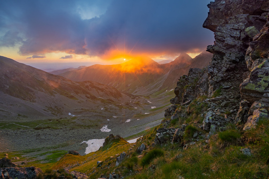 View of Smutne sedlo in Western Tatras with a dramatic sunset over mountain peaks and rocky slopes in Ziar Zilina Region Slovakia. View of Smutne sedlo in Western Tatras with a dramatic sunset over mountain peaks and rocky slopes in Ziar Zilina Region Slovakia.