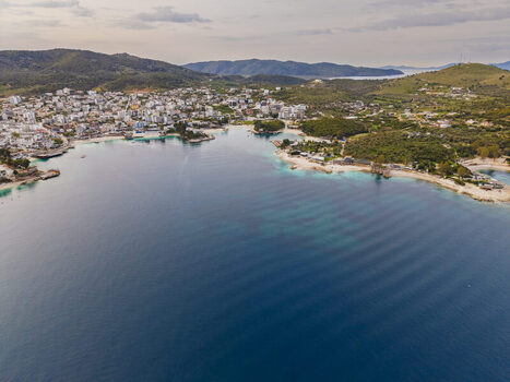Aerial view of the coastal town of Ksamil featuring turquoise waters sandy beaches and surrounding hills in Ksamil Vlore County Albania. Aerial view of the coastal town of Ksamil featuring turquoise waters sandy beaches and surrounding hills in Ksamil Vlore County Albania.