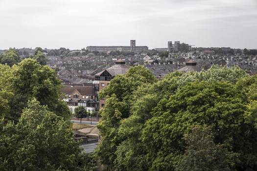 Aerial view of the historic city of York with its dense urban rooftops lush green trees and traditional architecture in York England United Kingdom.