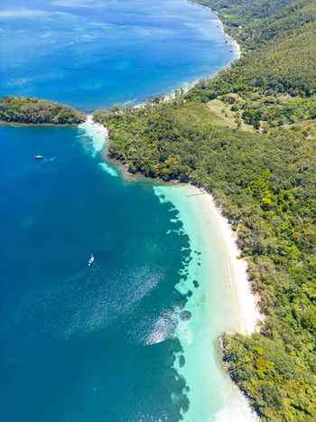 Aerial view of the tropical coastline of Guanaja island featuring white sand beaches and turquoise waters in Guanaja Bay Islands Department Honduras. Aerial view of the tropical coastline of Guanaja island featuring white sand beaches and turquoise waters in Guanaja Bay Islands Department Honduras.