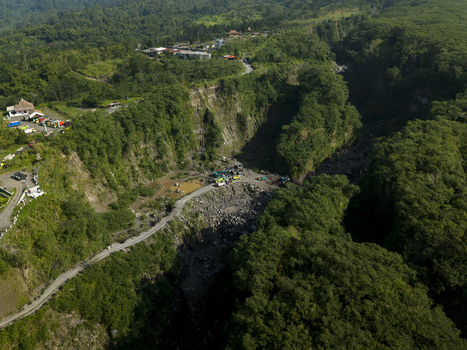 Aerial view of Tambang Pasir Merapi Kali Gendol Sand Mine with heavy machinery in the valley in Kecamatan Cangkringan Daerah Istimewa Yogyakarta Indonesia. Aerial view of Tambang Pasir Merapi Kali Gendol Sand Mine with heavy machinery in the valley in Kecamatan Cangkringan Daerah Istimewa Yogyakarta Indonesia.