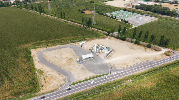 Aerial view of a modern biomethane production facility with a bioCNG and bioLNG fueling station surrounded by agricultural fields in Tavazzano con Villavesco Lombardy Italy.