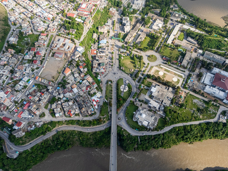 Aerial view of the city of Muzaffarabad featuring a bridge crossing the river dense urban residential areas and green public spaces in Muzaffarabad Azad Kashmir Pakistan. Aerial view of the city of Muzaffarabad featuring a bridge crossing the river dense urban residential areas and green public spaces in Muzaffarabad Azad Kashmir Pakistan.