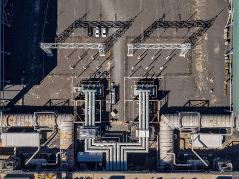Aerial view of the Millmerran Power Station showing industrial infrastructure with large pipes electrical transformers and gravel ground in Domville Queensland Australia. Aerial view of the Millmerran Power Station showing industrial infrastructure with large pipes electrical transformers and gravel ground in Domville Queensland Australia.