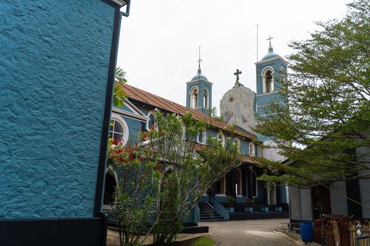 View of St. Mary s Cathedral featuring its distinct blue facade and twin bell towers under an overcast sky in Galle Southern Province Sri Lanka.