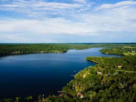 Aerial view of Commanda Lake surrounded by lush green forests and calm blue waters in Restoule Ontario Canada. Aerial view of Commanda Lake surrounded by lush green forests and calm blue waters in Restoule Ontario Canada.