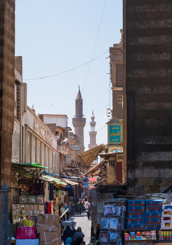 El Darb El Ahmar Egypt 20 April 2026 View of the historic Wikala of Al Ghouri complex with its towering minarets rising above a bustling street market filled with people and shops. El Darb El Ahmar Egypt 20 April 2026 View of the historic Wikala of Al Ghouri complex with its towering minarets rising above a bustling street market filled with people and shops.