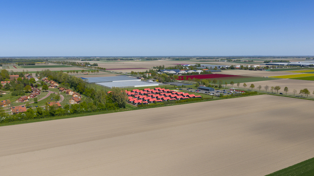 Drone view of AZC Luttelgeest in the Netherlands showing a reception centre for asylum seekers temporary housing community facilities and social infrastructure. Drone view of AZC Luttelgeest in the Netherlands showing a reception centre for asylum seekers temporary housing community facilities and social infrastructure.