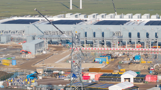 Groningen Netherlands 20 January 2026 Aerial view of Datacenter Westpoort under construction with cranes shipping containers and solar panels.
