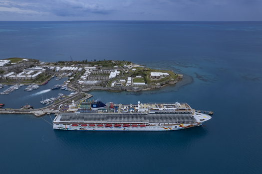 Royal Dockyard Bermuda 16 December 2022 Aerial view of the Norwegian Getaway cruise ship docked at the historic Royal Naval Dockyard surrounded by turquoise waters and coastal fortifications. Royal Dockyard Bermuda 16 December 2022 Aerial view of the Norwegian Getaway cruise ship docked at the historic Royal Naval Dockyard surrounded by turquoise waters and coastal fortifications.