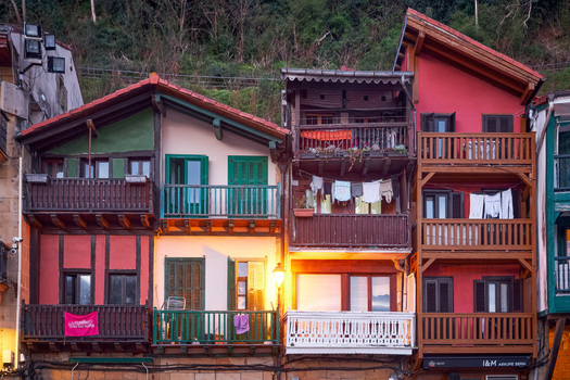 Pasai Donibane Spain 09 March 2026 View of colorful traditional houses with wooden balconies and laundry hanging in the historic harbor street.