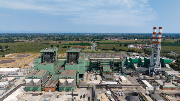 Aerial view of the Tavazzano power station a combined cycle natural gas facility with green industrial buildings and a tall chimney in Tavazzano con Villavesco Lombardy Italy.