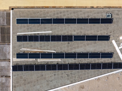 Aerial view of solar panels installed on a flat concrete rooftop in Cascais Lisboa Portugal.