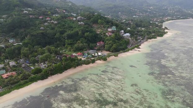 Aerial view of Mahe coastline and lush hills in Seychelles.