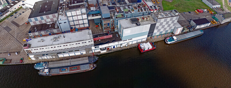 Wormer Netherlands 10 April 2026 Aerial view of Olam International Cacoa factory De Moriaan its stark white walls contrasting with the dark glossy water and docked barges. Wormer Netherlands 10 April 2026 Aerial view of Olam International Cacoa factory De Moriaan its stark white walls contrasting with the dark glossy water and docked barges.