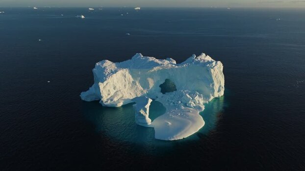 Aerial view of arch iceberg in the Arctic Ocean Greenland. Aerial view of arch iceberg in the Arctic Ocean Greenland.