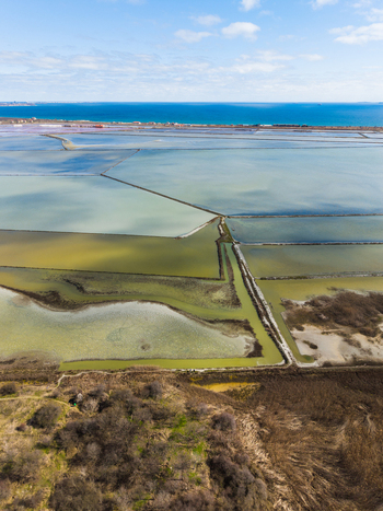 Aerial view of Lake Atanasovsko with its colorful salt evaporation ponds and narrow dikes near the Black Sea in Burgas Burgas Bulgaria. Aerial view of Lake Atanasovsko with its colorful salt evaporation ponds and narrow dikes near the Black Sea in Burgas Burgas Bulgaria.