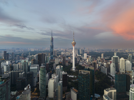 Kuala Lumpur Malaysia 11 March 2026 Aerial view of the KL Tower and Merdeka 118 skyscraper amidst the dense urban skyline under a colorful sunset sky.