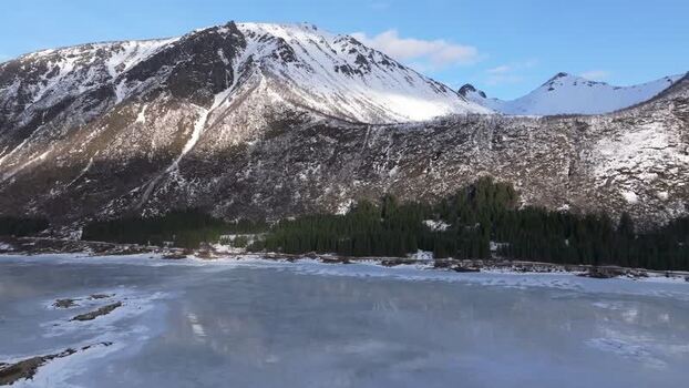 Aerial view of Lofoten mountains and frozen lake Norway.