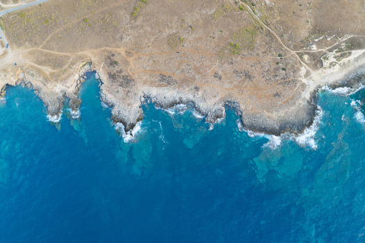 Aerial view of Riserva Naturale Orientata dello Zingaro with rugged rocky coastline turquoise sea and dry Mediterranean landscape in San Vito Lo Capo Sicilia Italy. Aerial view of Riserva Naturale Orientata dello Zingaro with rugged rocky coastline turquoise sea and dry Mediterranean landscape in San Vito Lo Capo Sicilia Italy.