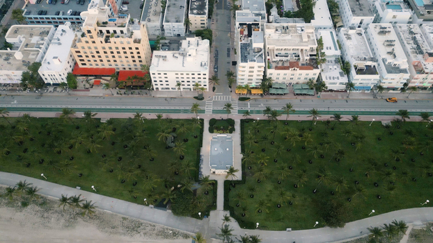 Aerial view of Miami Beach featuring the iconic Art Deco architecture lush palm lined park and coastal urban layout in Miami Beach Florida United States. Aerial view of Miami Beach featuring the iconic Art Deco architecture lush palm lined park and coastal urban layout in Miami Beach Florida United States.